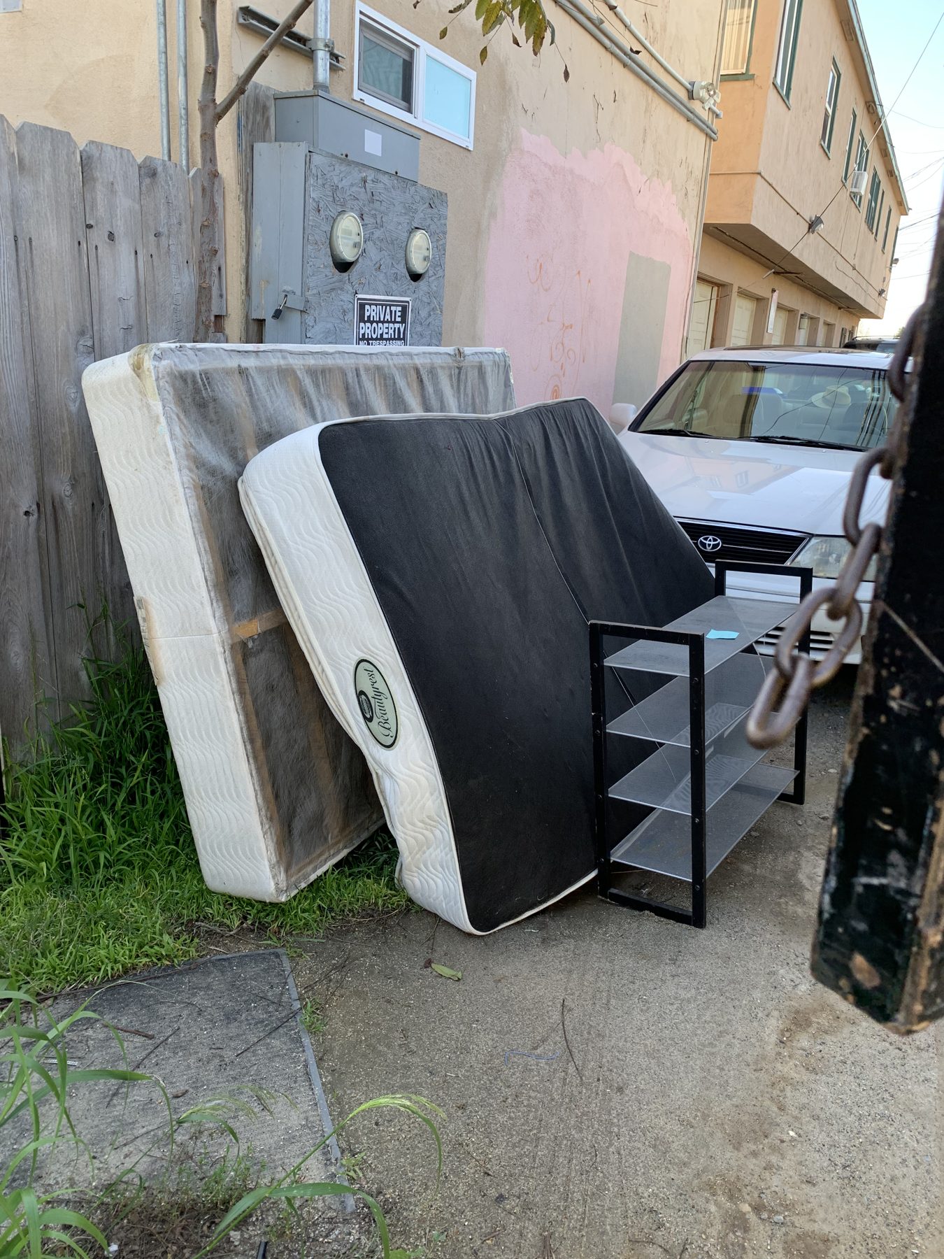 Mattresses leaning in a San Diego alley waiting for disposal