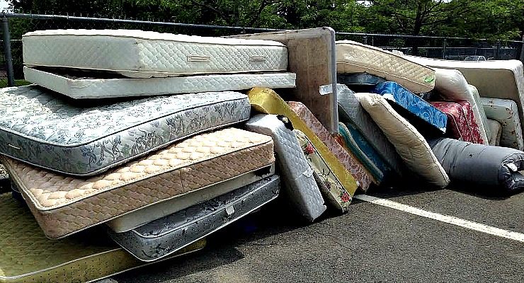 Pile of discarded mattresses ready for haul-away